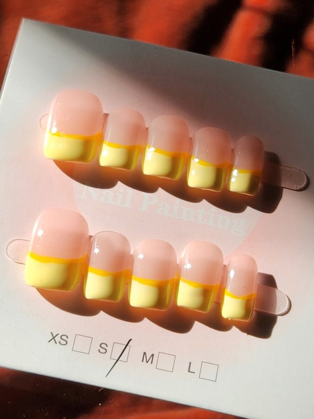 Short square yellow french-tip press-on nails. Size small.